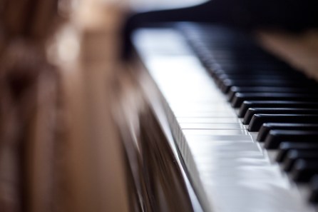 Piano keyboard background with selective focus. Warm color toned image